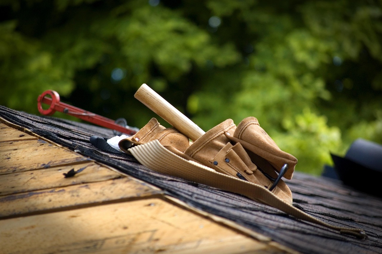 Certified roofer conducting roof inspection at a residential property
